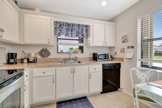 kitchen featuring white cabinets, stainless steel appliances, light tile patterned flooring, and sink