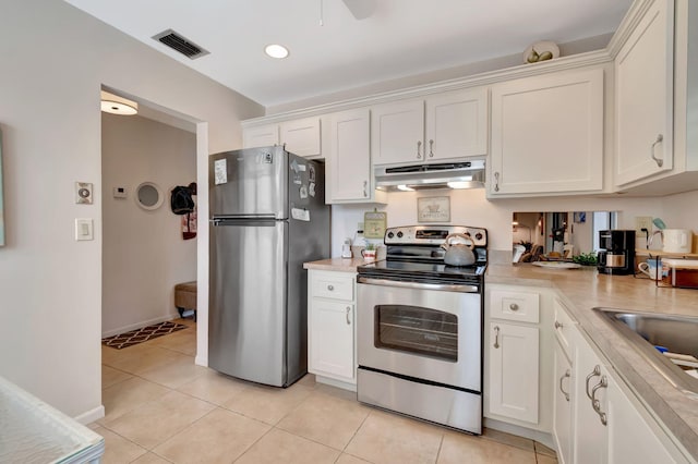 kitchen with appliances with stainless steel finishes, ceiling fan, and white cabinets