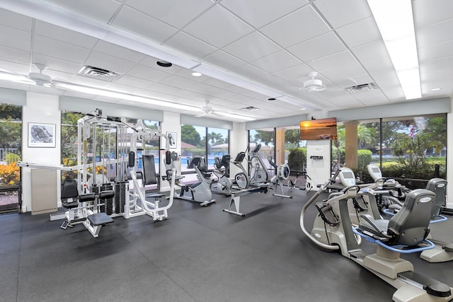 workout area featuring a paneled ceiling and ceiling fan