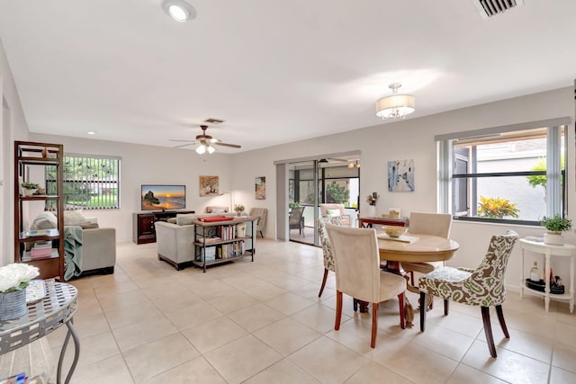 tiled dining space with ceiling fan