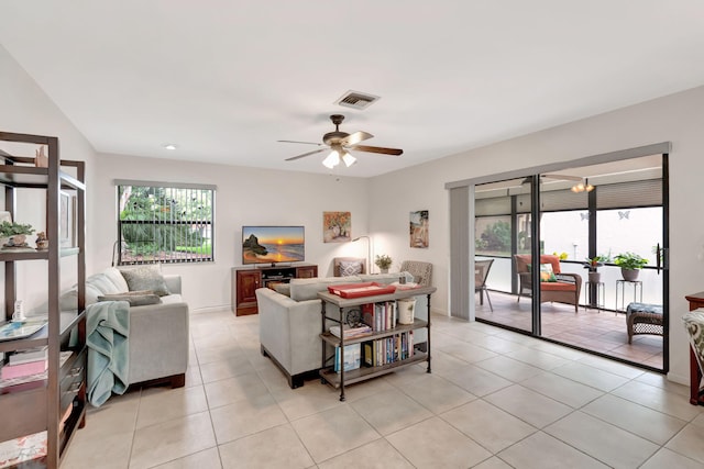 living room with light tile patterned floors, ceiling fan, and a wealth of natural light