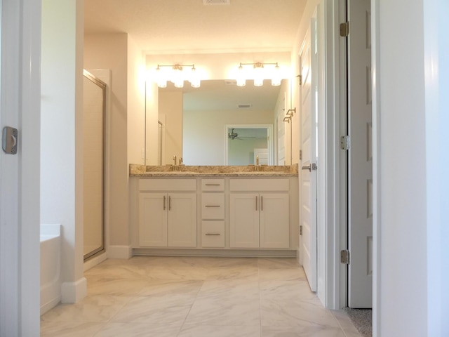 bathroom with ceiling fan, vanity, and shower with separate bathtub