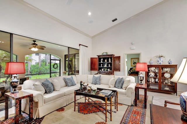 living room featuring light tile patterned floors, crown molding, ceiling fan, and high vaulted ceiling