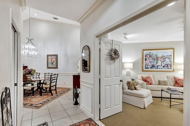 interior space with a chandelier and crown molding