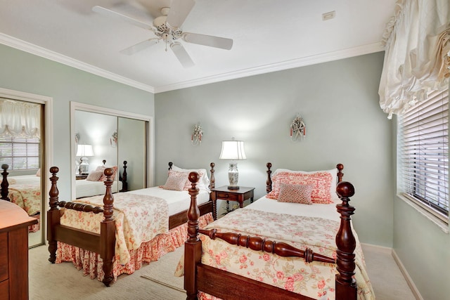 bedroom featuring crown molding, ceiling fan, light colored carpet, and a closet