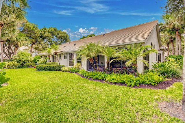 back of property featuring a lawn