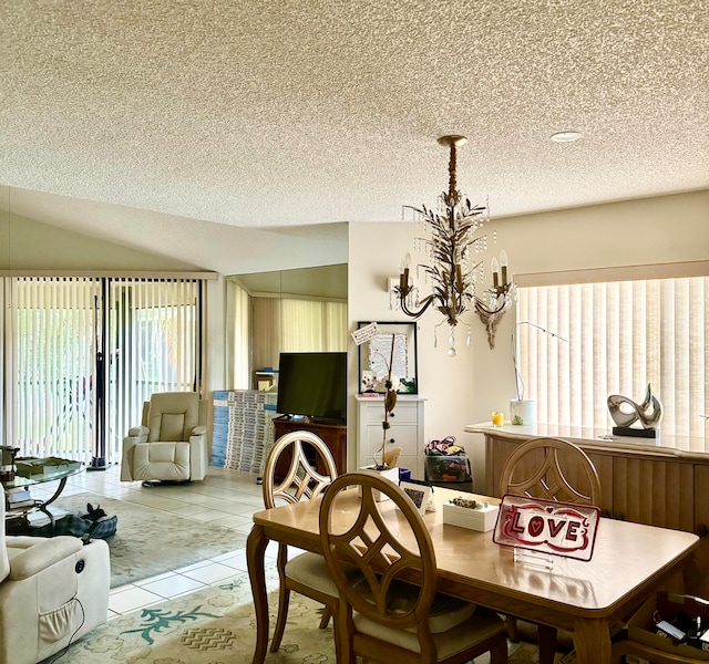 dining room featuring light tile patterned floors, a textured ceiling, lofted ceiling, and a chandelier