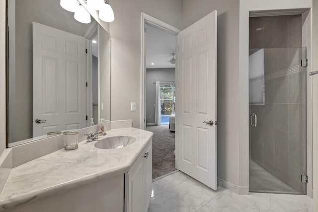 bathroom with vanity, an enclosed shower, and ceiling fan