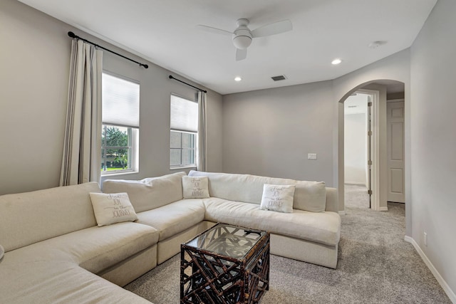 carpeted living room with ceiling fan