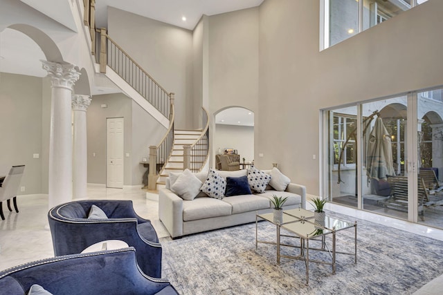 living room with a high ceiling and decorative columns