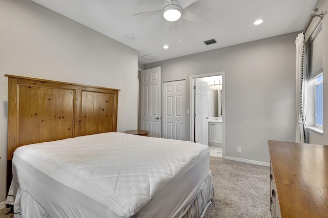 carpeted bedroom with ceiling fan and ensuite bathroom