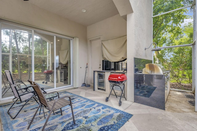 view of patio / terrace with beverage cooler and area for grilling