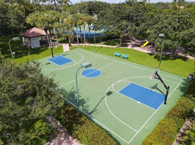 view of sport court with a lawn