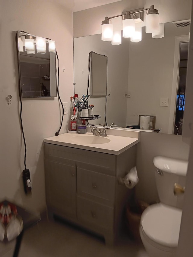 bathroom featuring toilet and vanity