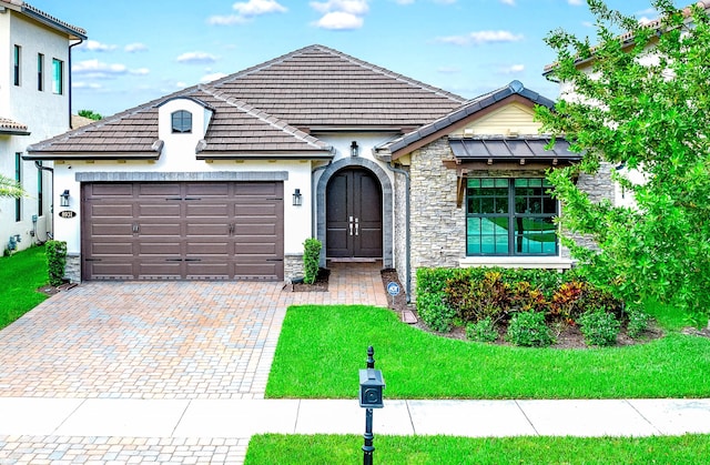 view of front of property with a garage and a front lawn