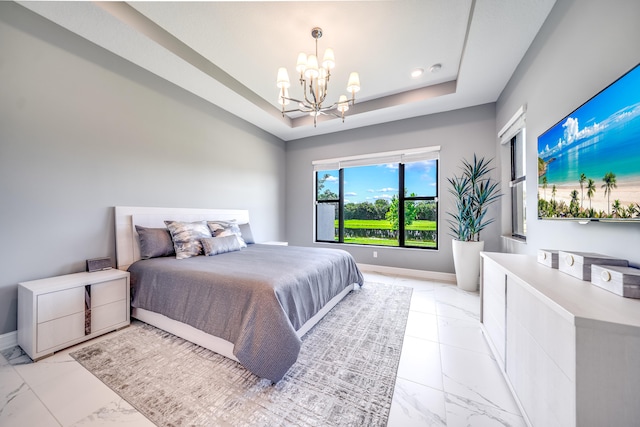 bedroom featuring a tray ceiling and an inviting chandelier