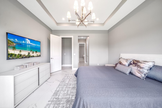 bedroom with a tray ceiling and an inviting chandelier