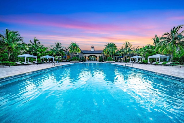 pool at dusk with a patio