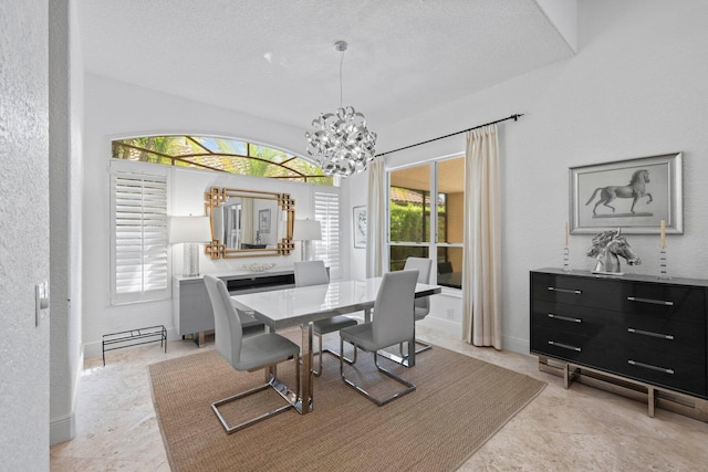 dining area with a chandelier, a textured ceiling, and a healthy amount of sunlight