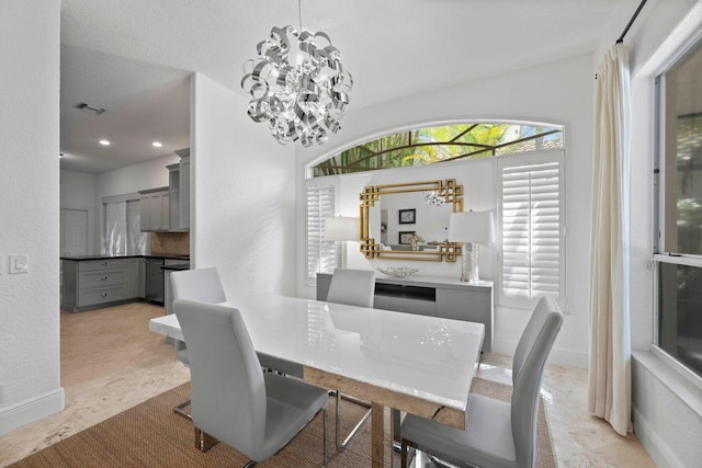 dining space with a notable chandelier and a textured ceiling