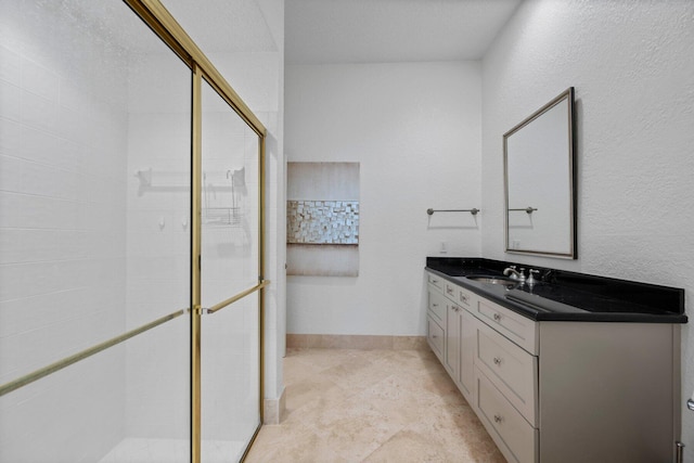 bathroom featuring vanity and a shower with shower door