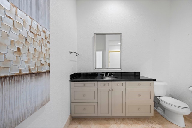 bathroom featuring vanity, toilet, and tile patterned floors