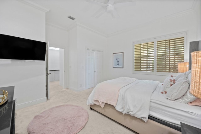 carpeted bedroom featuring crown molding, ceiling fan, and a closet