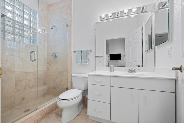 bathroom featuring tile patterned flooring, toilet, a shower with door, and vanity