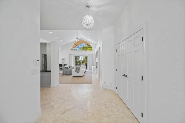 entryway featuring vaulted ceiling and a notable chandelier