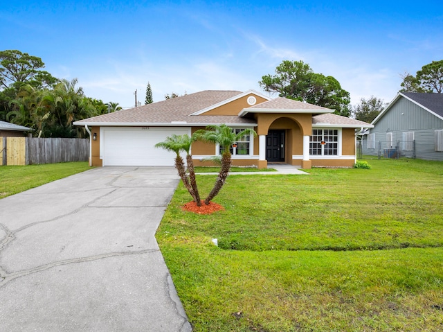 ranch-style home featuring a garage and a front yard