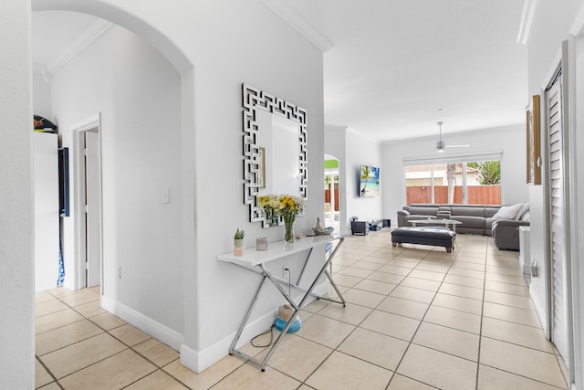 hall featuring light tile patterned floors and ornamental molding