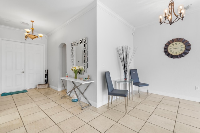 tiled foyer entrance with a chandelier and ornamental molding