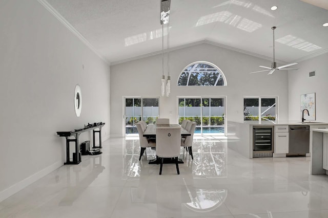 dining area featuring high vaulted ceiling, ornamental molding, wine cooler, sink, and ceiling fan