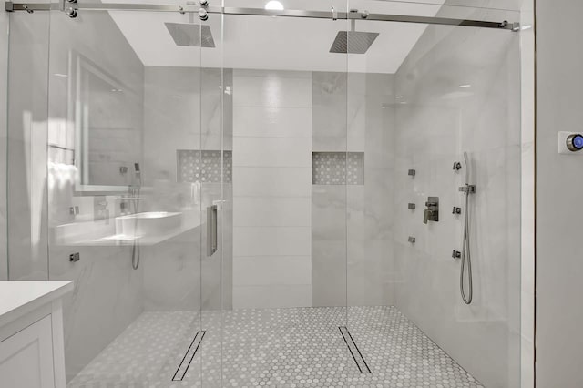 bathroom with a shower with shower door, vaulted ceiling, and vanity