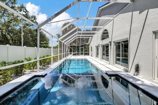 view of pool with an in ground hot tub and a lanai