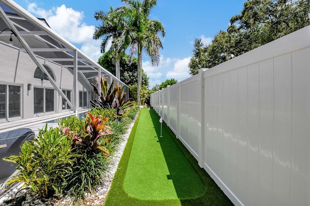 view of yard featuring glass enclosure