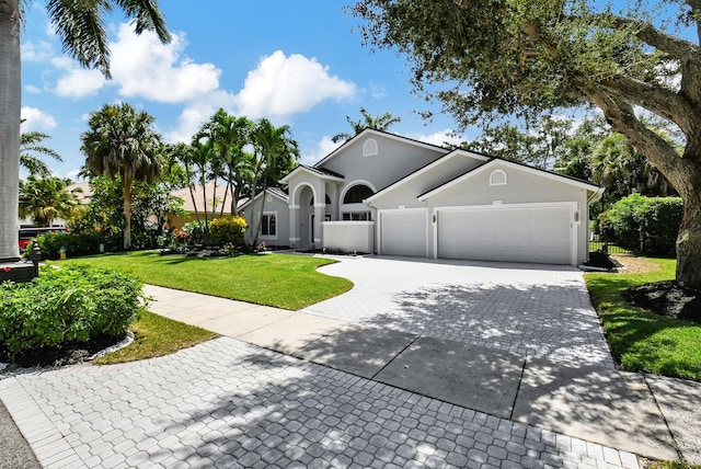 view of front of house with a garage and a front yard