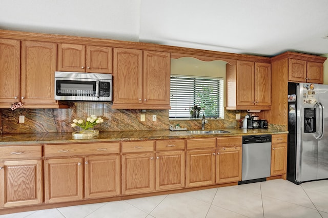 kitchen with decorative backsplash, stainless steel appliances, light tile patterned floors, and sink