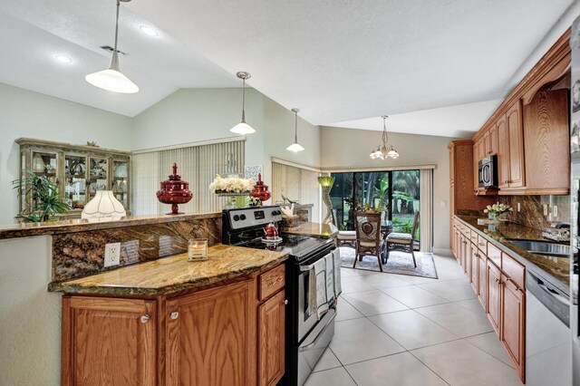 11111 Highland Cir, Boca Raton, FL 33428 - kitchen with appliances with stainless steel finishes, brown cabinetry, backsplash, a sink, and a chandelier