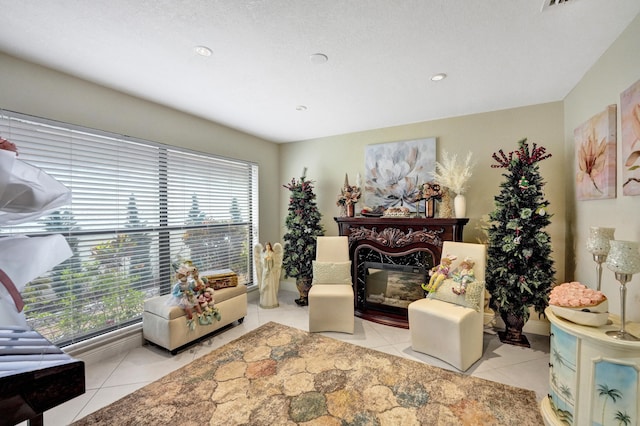 sitting room featuring a textured ceiling and tile patterned floors