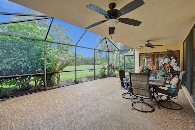 unfurnished sunroom with a healthy amount of sunlight and ceiling fan