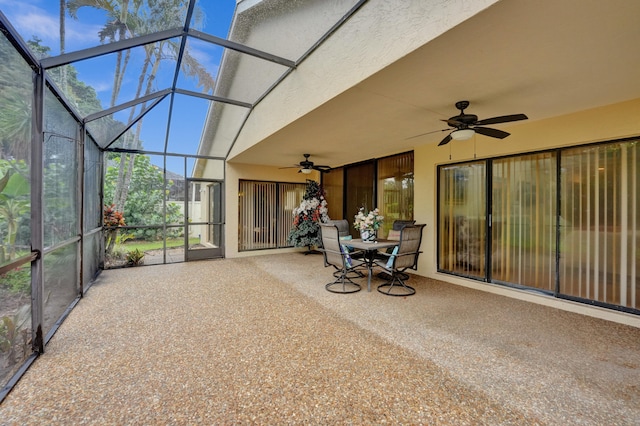 unfurnished sunroom with ceiling fan