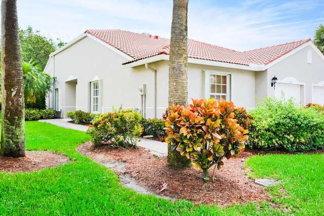 view of property exterior with a lawn and a garage