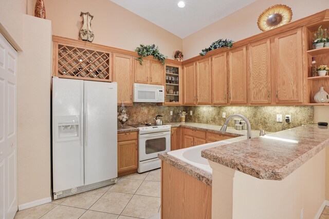 kitchen with kitchen peninsula, sink, light tile patterned floors, and white appliances