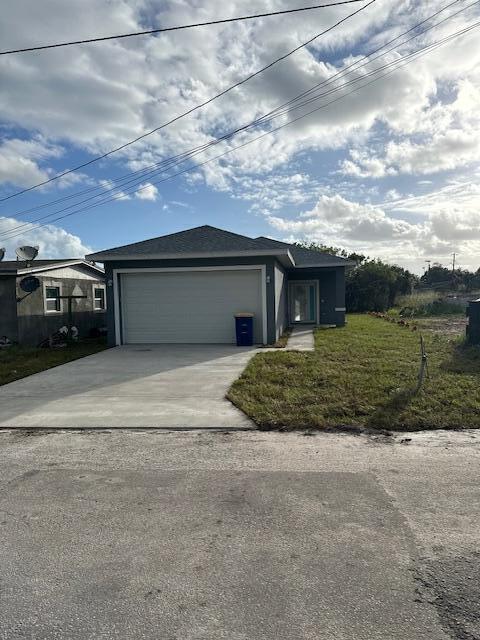 view of front of property with a garage and a front yard