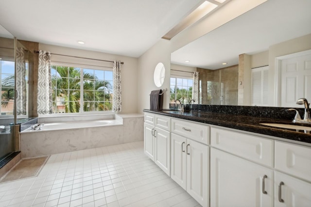 bathroom with plus walk in shower, tile patterned floors, and vanity