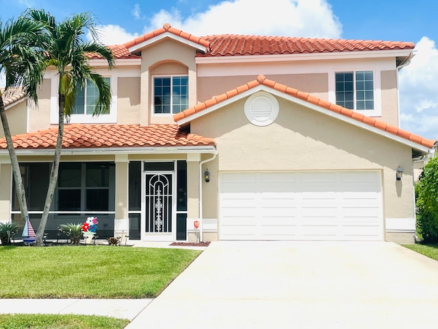 mediterranean / spanish house featuring covered porch, a front yard, and a garage