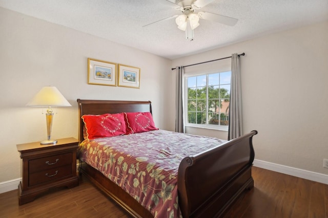 bedroom featuring a textured ceiling, ceiling fan, and dark hardwood / wood-style flooring