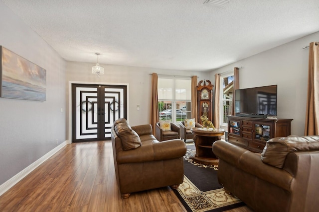 living room with hardwood / wood-style flooring and a textured ceiling