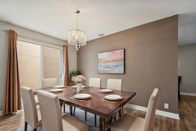 dining room featuring an inviting chandelier and wood-type flooring